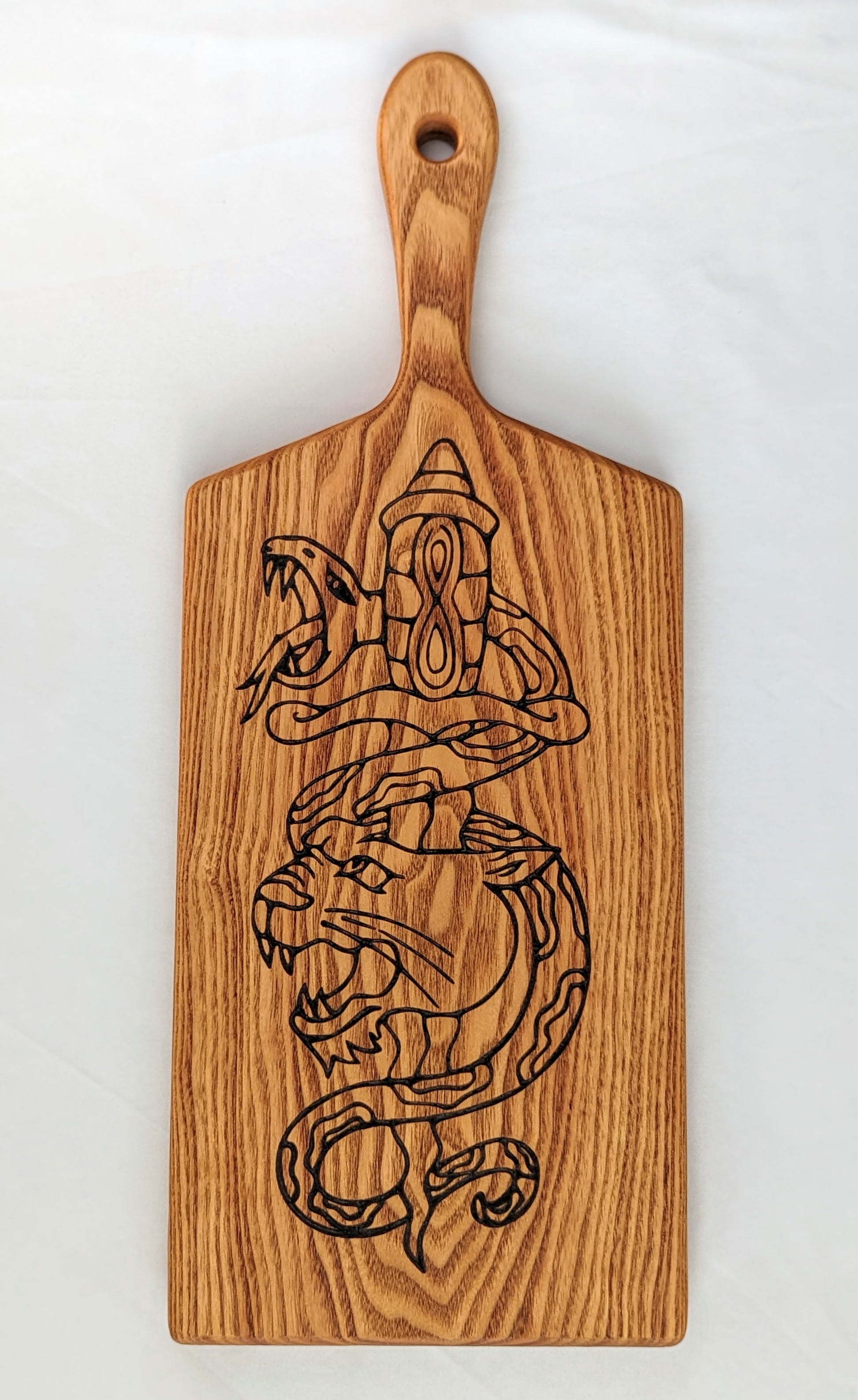 Coffeenut serving board featuring a traditional tattoo design that includes a panther and snake. 